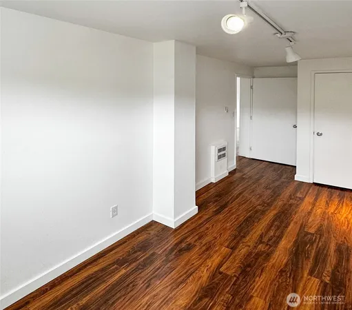 a view of an empty room and wooden floor