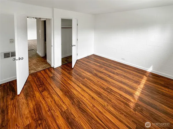 a bedroom with a bed and painting on the wall