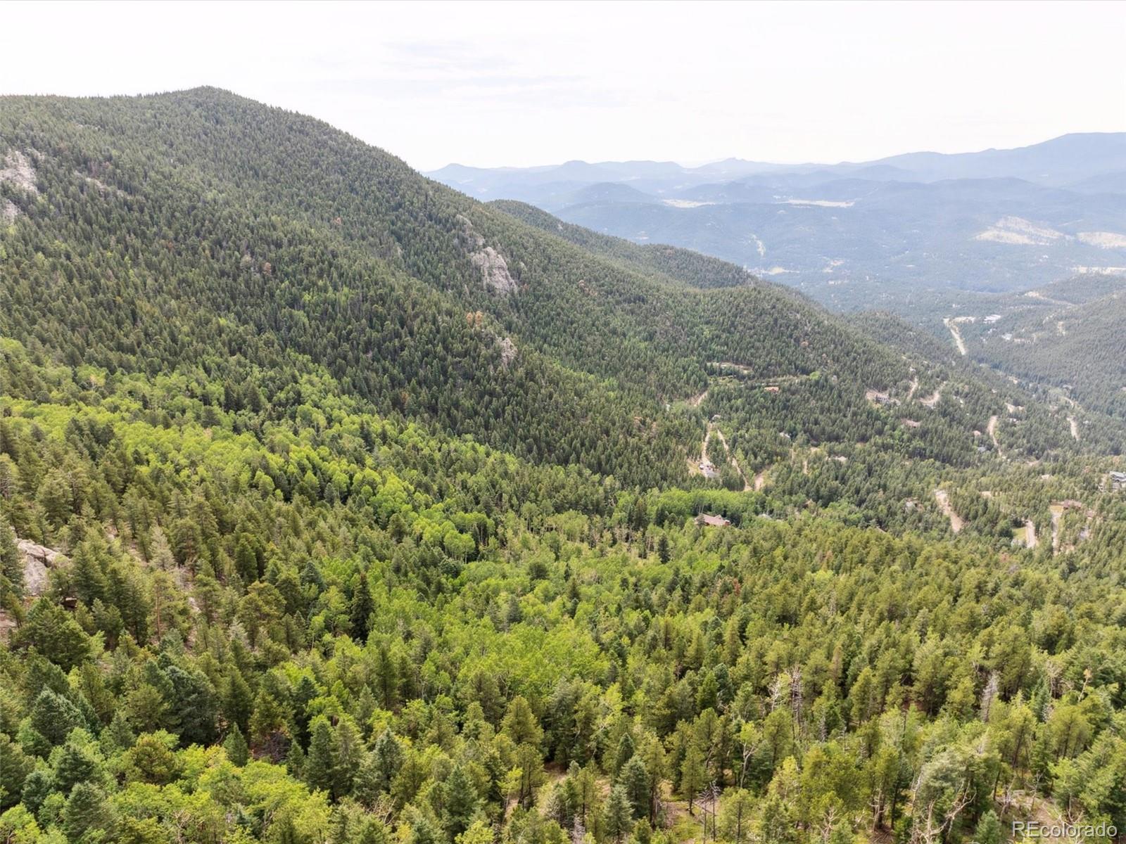 0 Snyder Mountain Road Evergreen, CO 80439 - Photo 20 of 46 a view of a mountain range with lush green forest