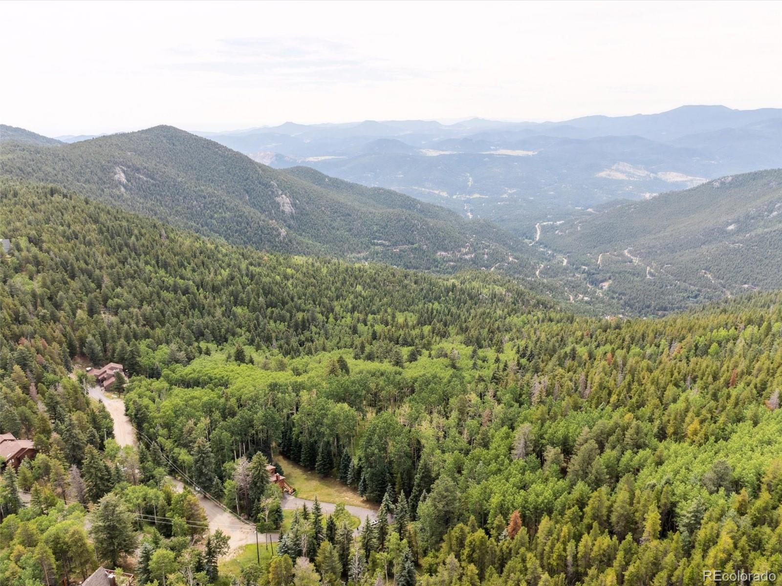 0 Snyder Mountain Road Evergreen, CO 80439 - Photo 2 of 46 a view of a mountain range with lush green forest