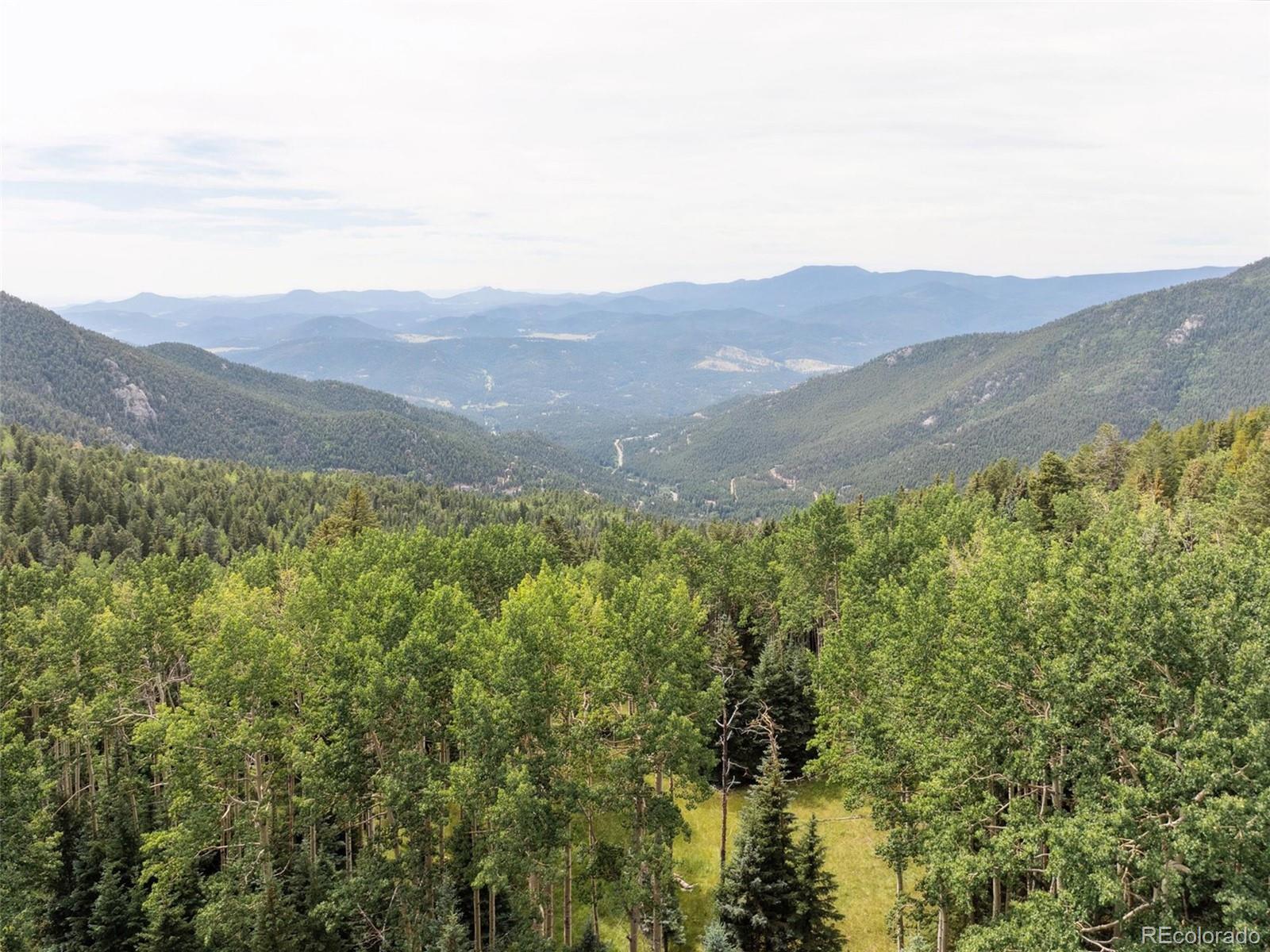 0 Snyder Mountain Road Evergreen, CO 80439 - Photo 22 of 46 a view of a mountain range with lush green forest