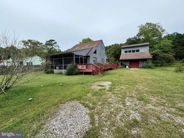 a view of a house with a yard and sitting area