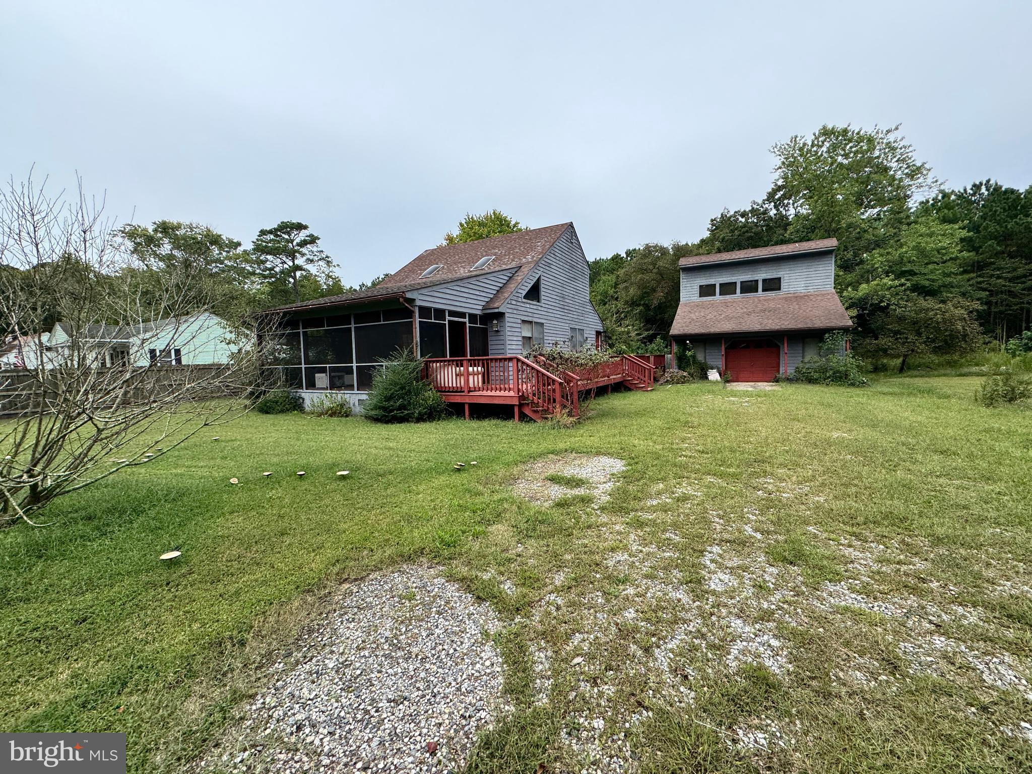 a view of a house with a yard and sitting area