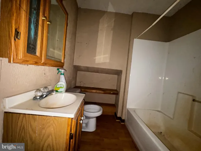 a bathroom with a sink toilet and tub