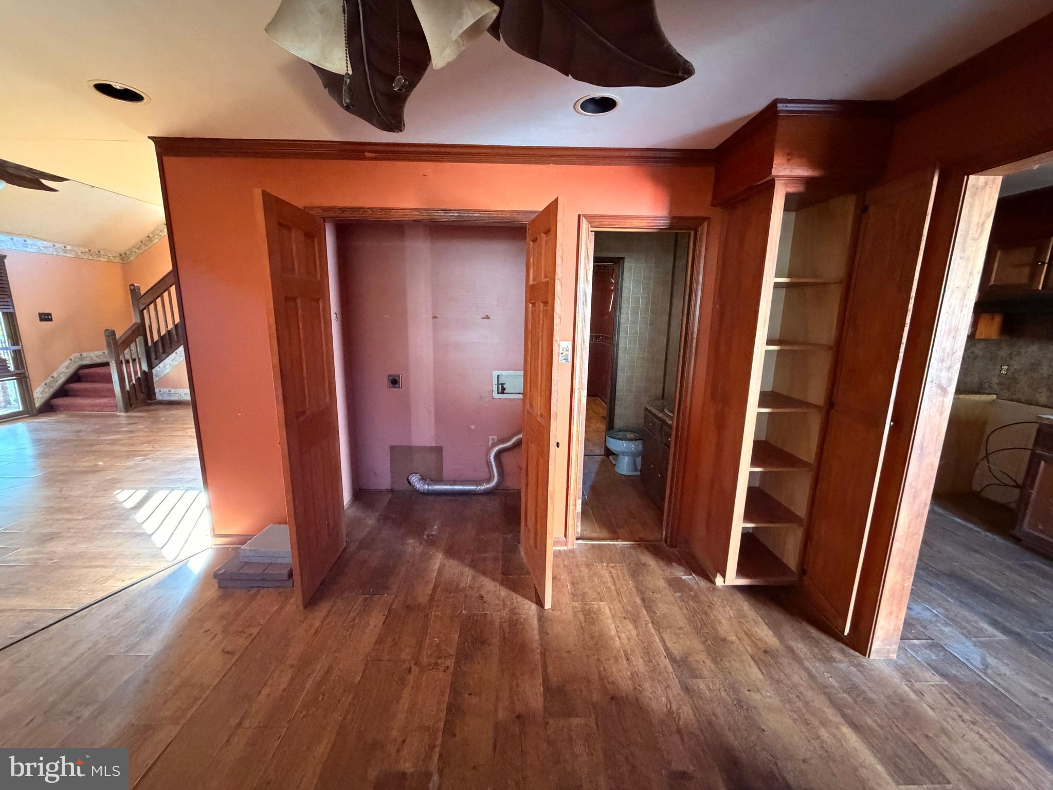 23540 Deal Island Road Chance, MD 21821 - Photo 20 of 41 a view of a hallway with wooden floor and stairs