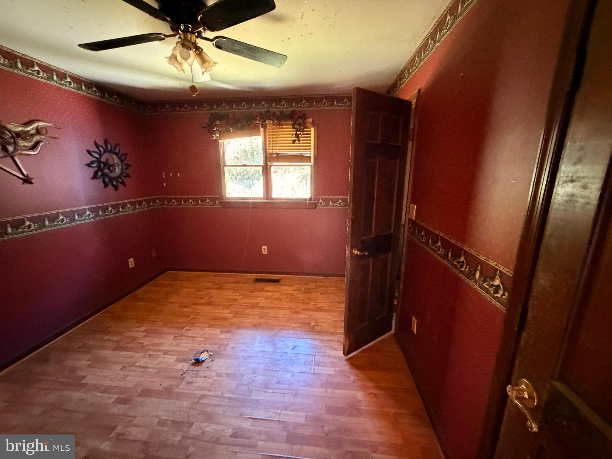 23540 Deal Island Road Chance, MD 21821 - Photo 27 of 41 en empty room with wooden floor and windows