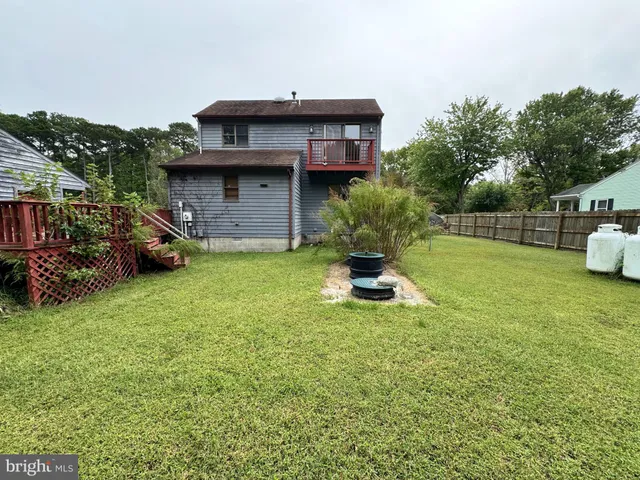 a view of a backyard with sitting area and slide