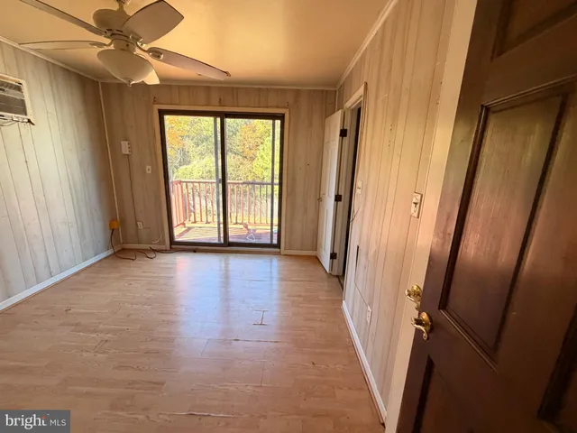 a view of an entryway with wooden floor and door