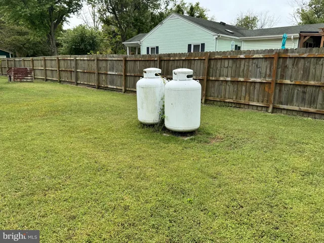 a view of a backyard with wooden fence
