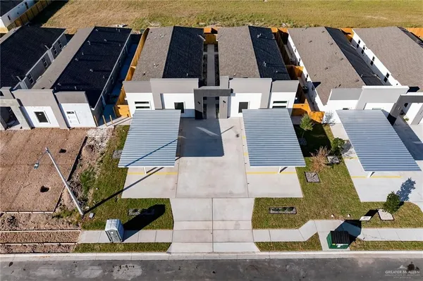 an aerial view of residential houses with outdoor space