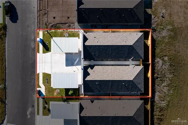 an aerial view of residential houses with outdoor space