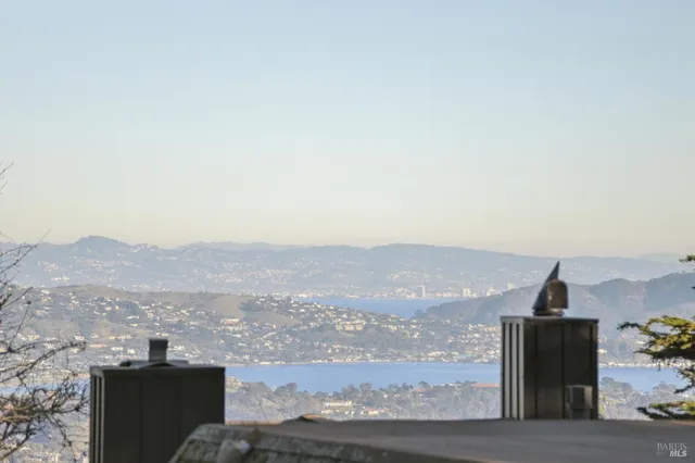 a living room with furniture and three windows