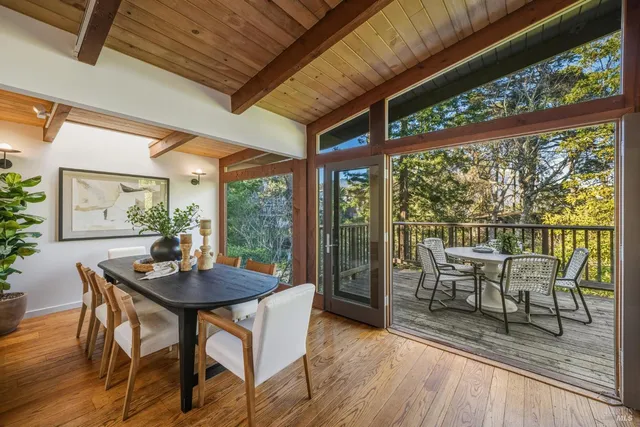a dining room with furniture and a window