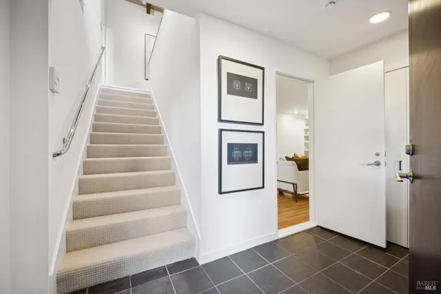 a living room with furniture and large windows