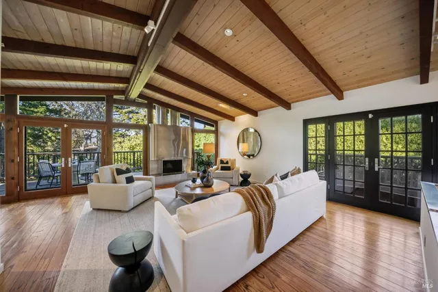 a living room with furniture a fireplace and a large window