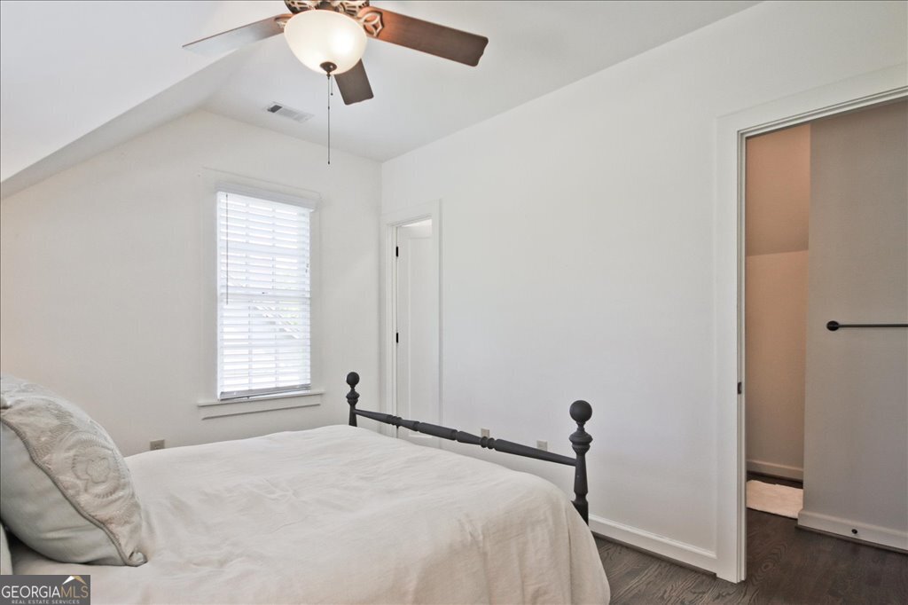 109 Coneflower Lane Toccoa, GA 30577 - Photo 27 of 49 a bedroom with a bed and a chandelier