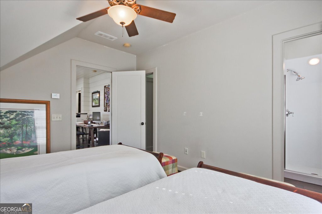 109 Coneflower Lane Toccoa, GA 30577 - Photo 30 of 49 a bedroom with a large bed and a chandelier