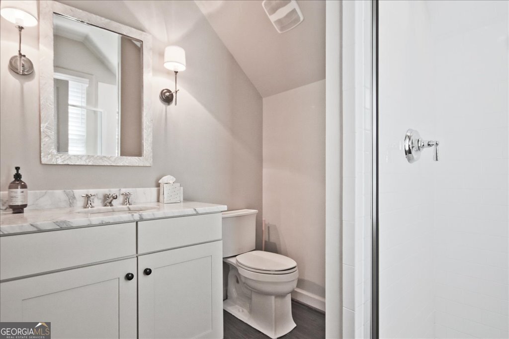 109 Coneflower Lane Toccoa, GA 30577 - Photo 31 of 49 a bathroom with a toilet sink vanity granite and mirror