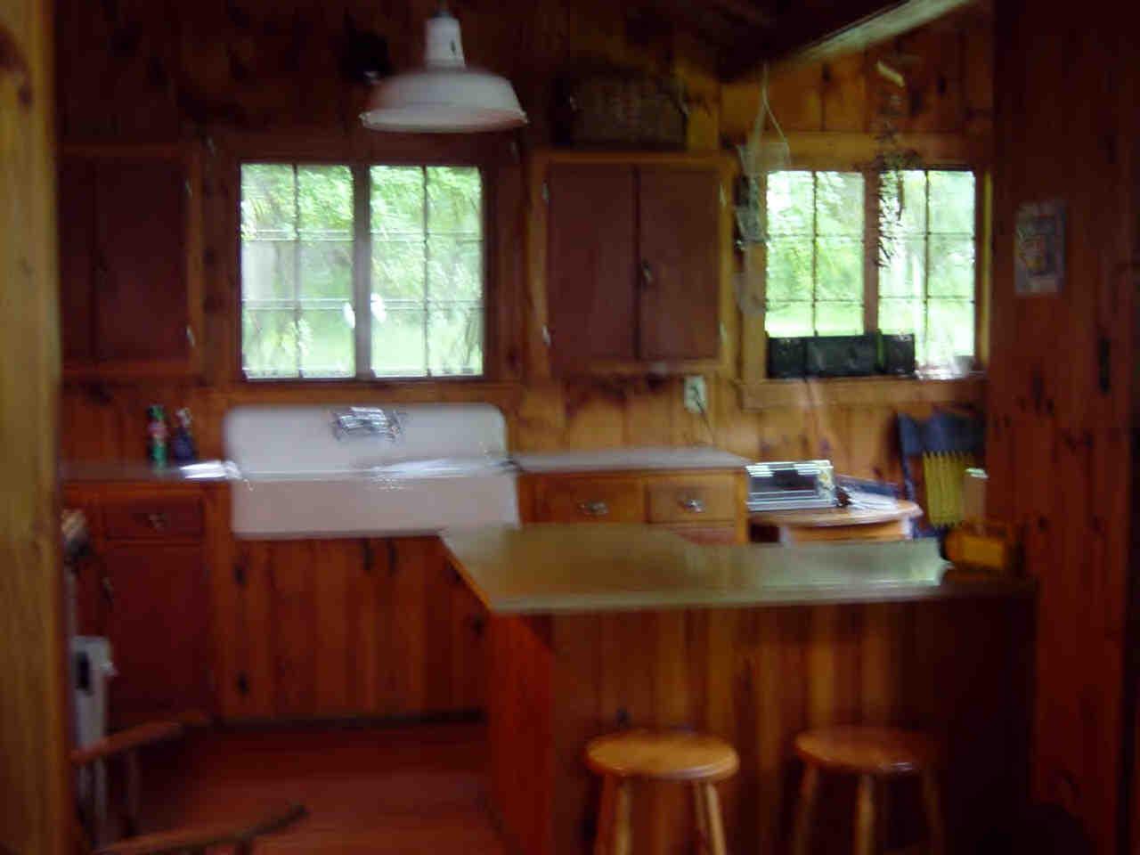 14 Mahkeenac Heights Road Stockbridge, MA 01262 - Photo 4 of 4 a kitchen with a sink a window and chairs