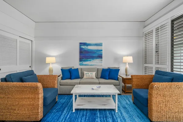 a living room with furniture and a lamp