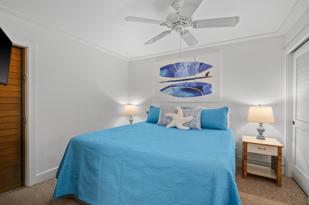 2253 Poipu Road, Unit 440 Koloa, HI 96756 - Photo 12 of 24 a bedroom with a bed and a chandelier