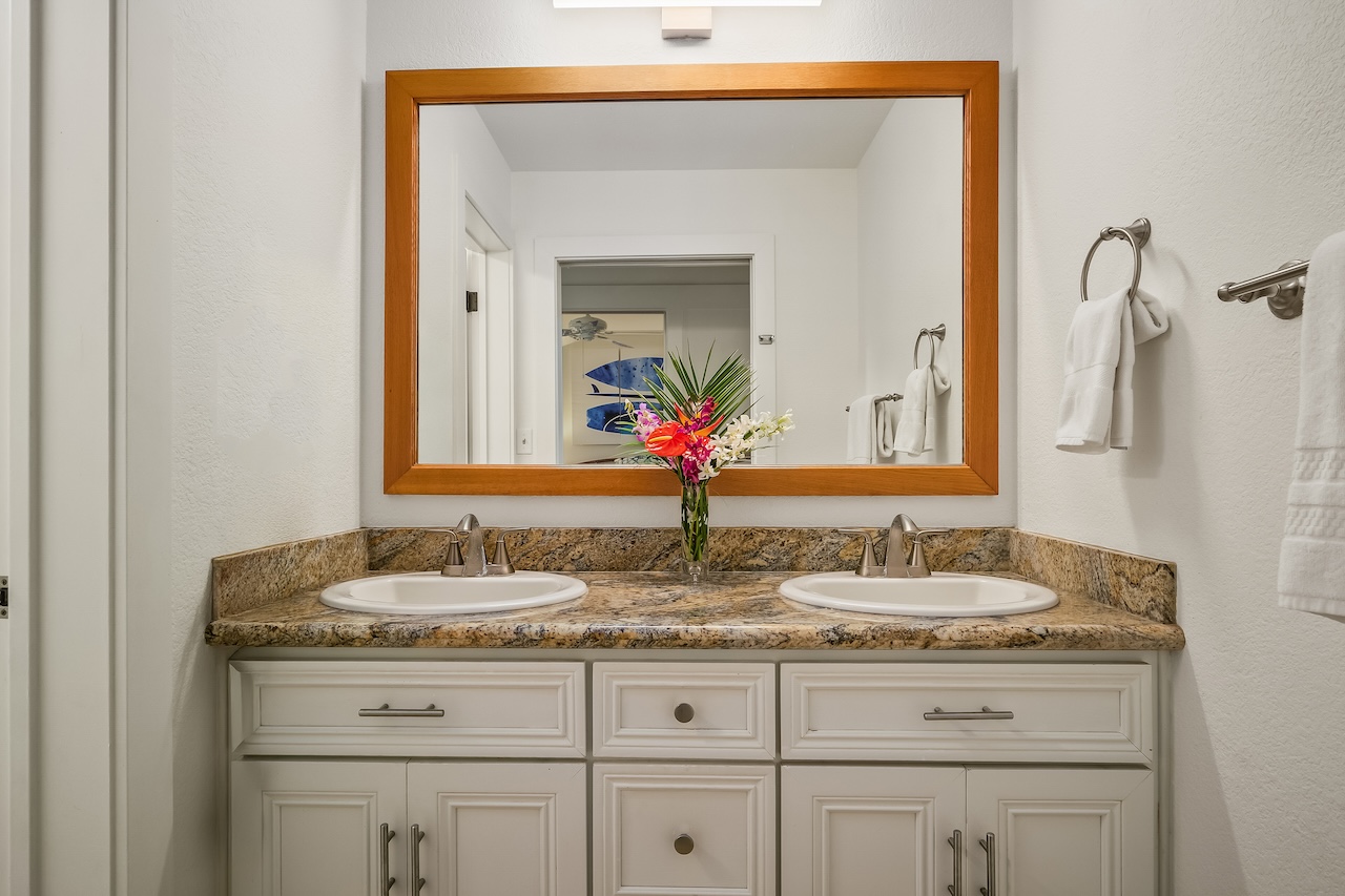 2253 Poipu Road, Unit 440 Koloa, HI 96756 - Photo 15 of 24 a bathroom with a granite countertop sink vanity and mirror