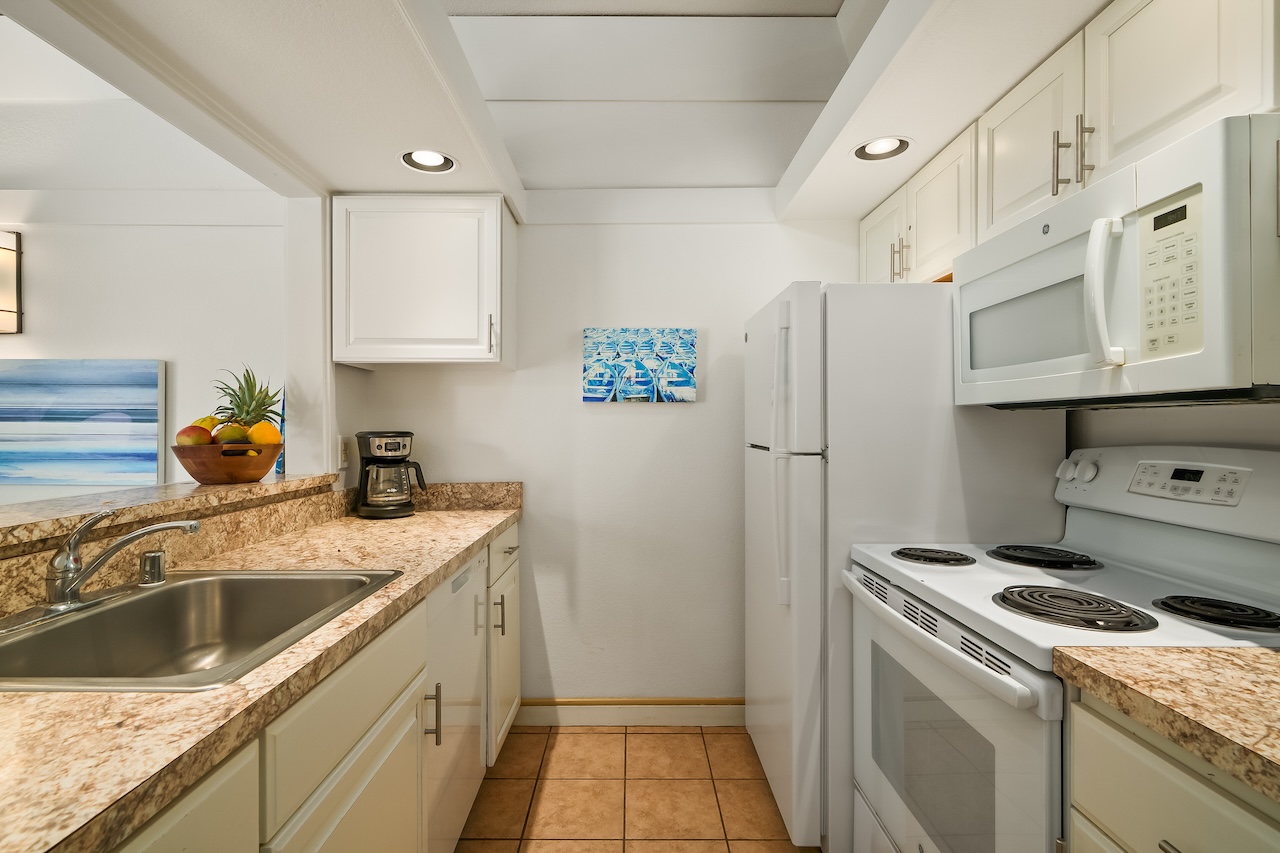 2253 Poipu Road, Unit 440 Koloa, HI 96756 - Photo 9 of 24 a kitchen with a sink a stove and refrigerator