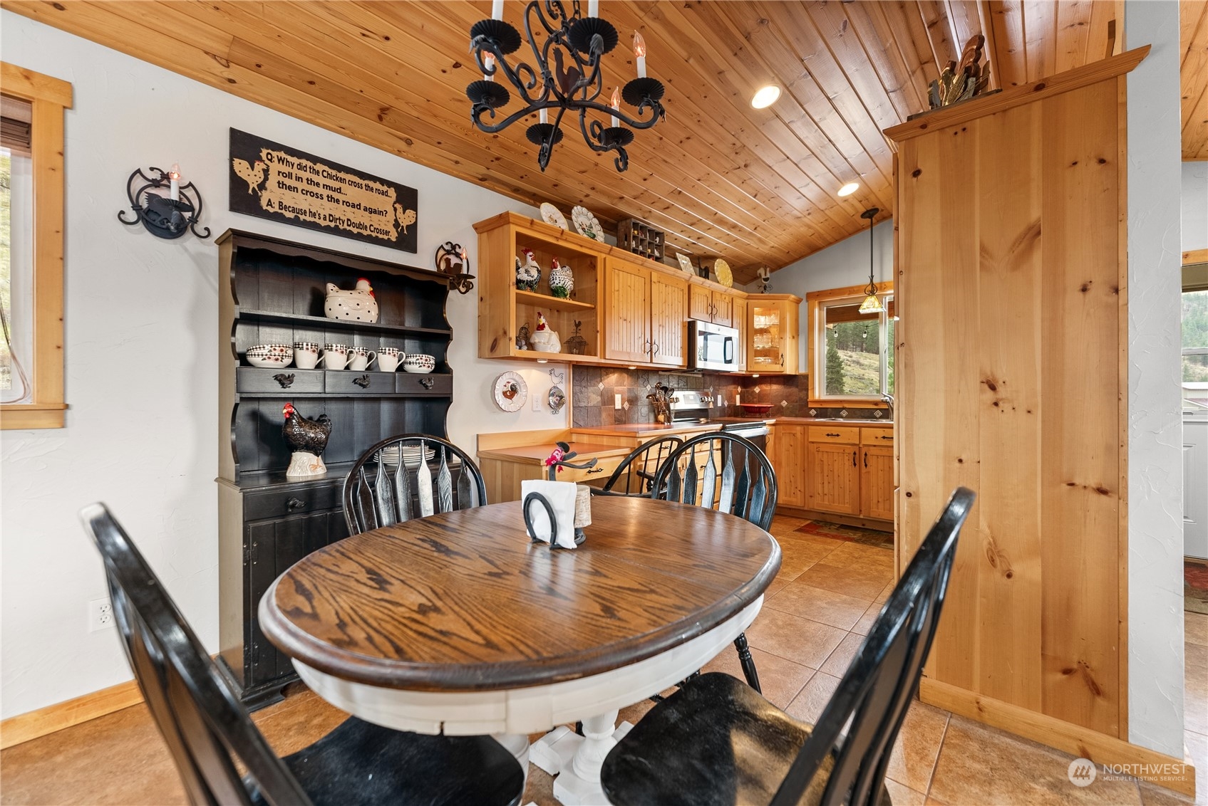 369 Tunk Creek Road Riverside, WA 98849 - Photo 24 of 40 a dining room with furniture and wooden floor