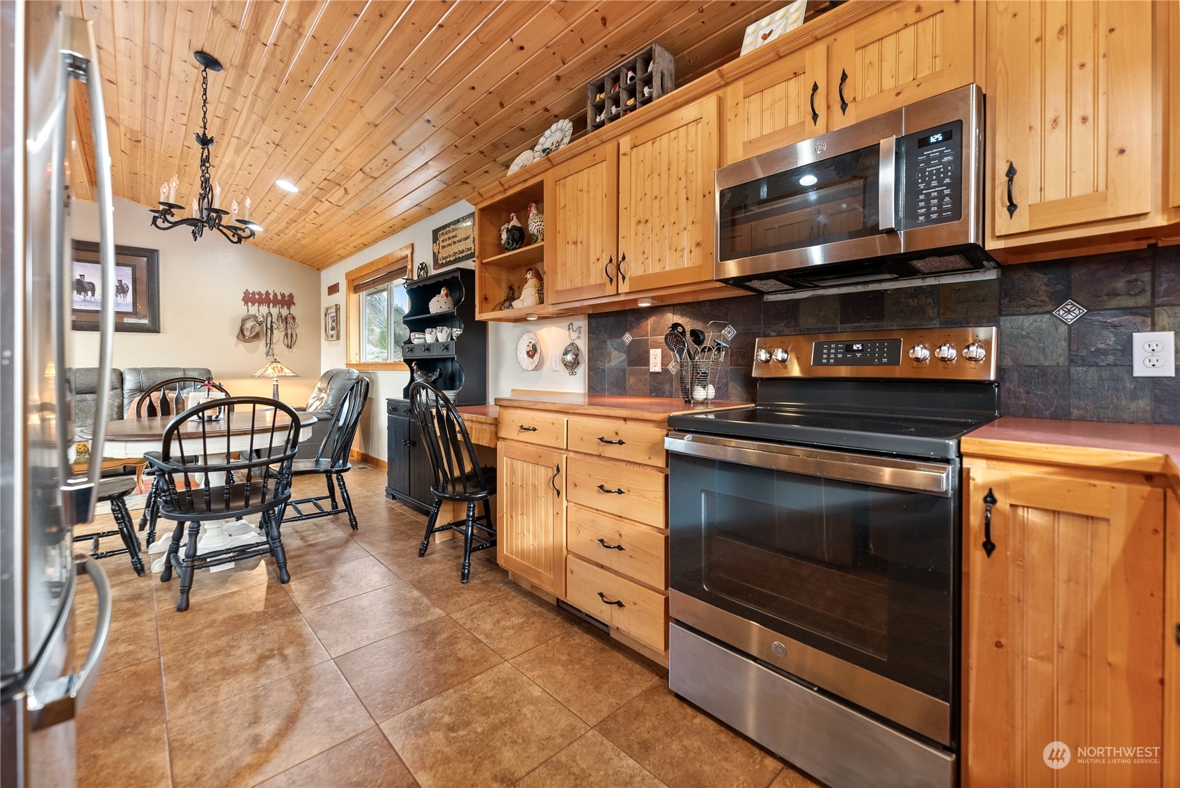 369 Tunk Creek Road Riverside, WA 98849 - Photo 25 of 40 a kitchen with stainless steel appliances granite countertop a stove and a microwave
