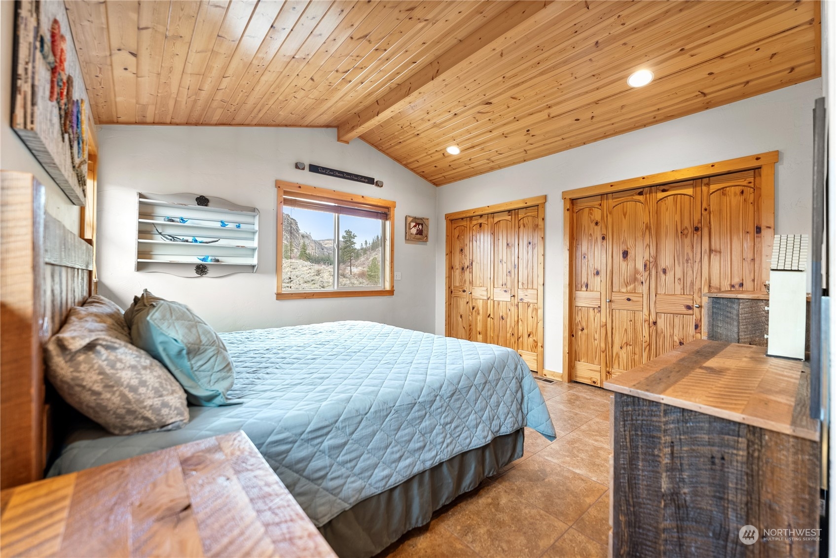369 Tunk Creek Road Riverside, WA 98849 - Photo 27 of 40 a bedroom with a large bed and a window