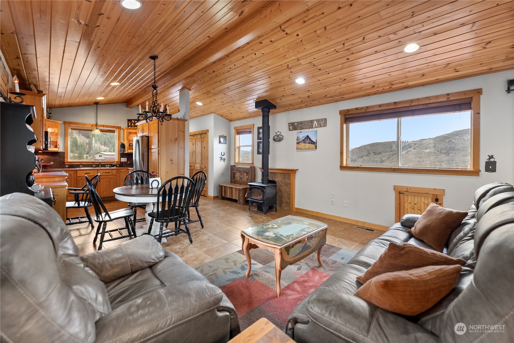 369 Tunk Creek Road Riverside, WA 98849 - Photo 31 of 40 a living room with furniture a rug kitchen view and a large window