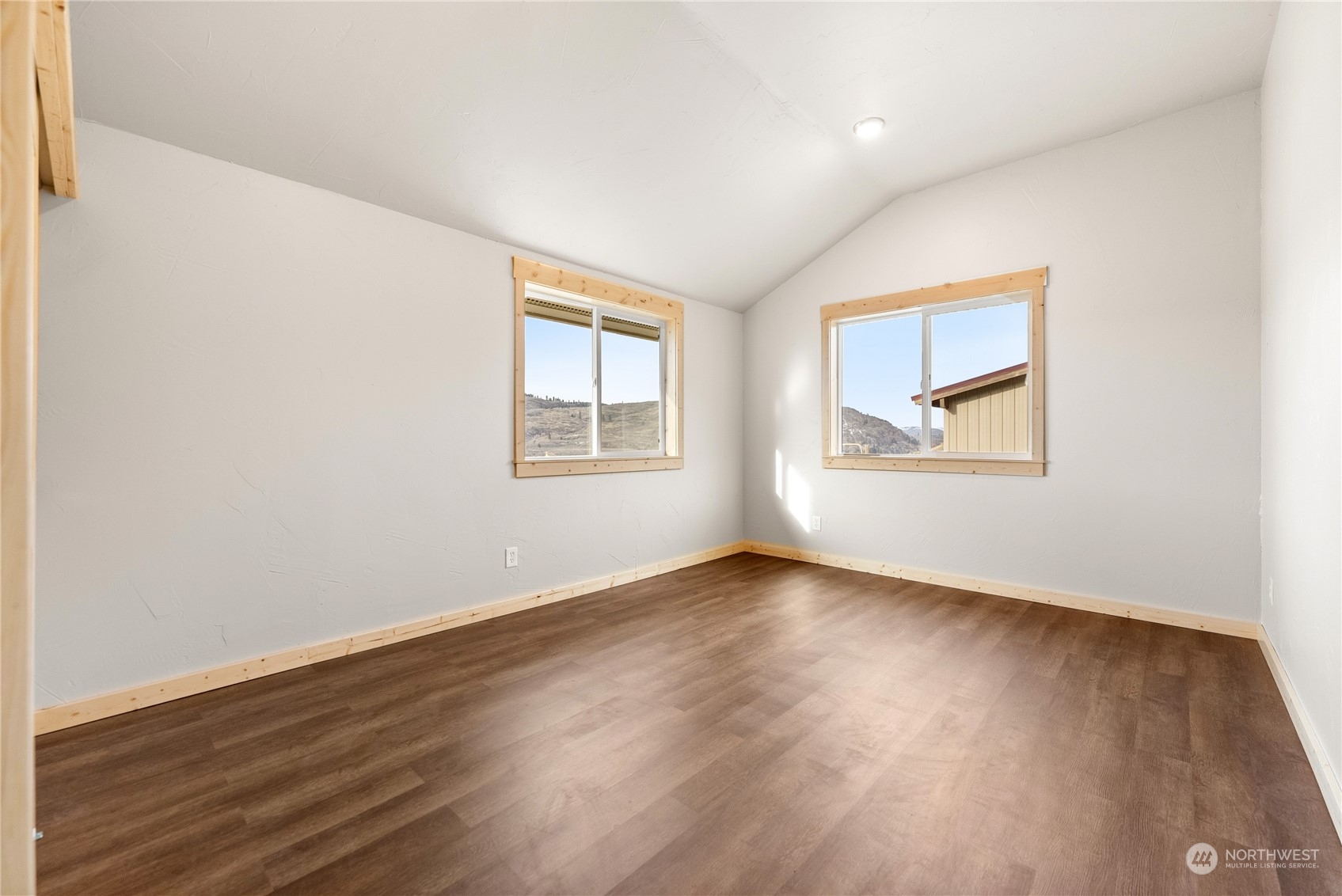 369 Tunk Creek Road Riverside, WA 98849 - Photo 35 of 40 an empty room with wooden floor and windows