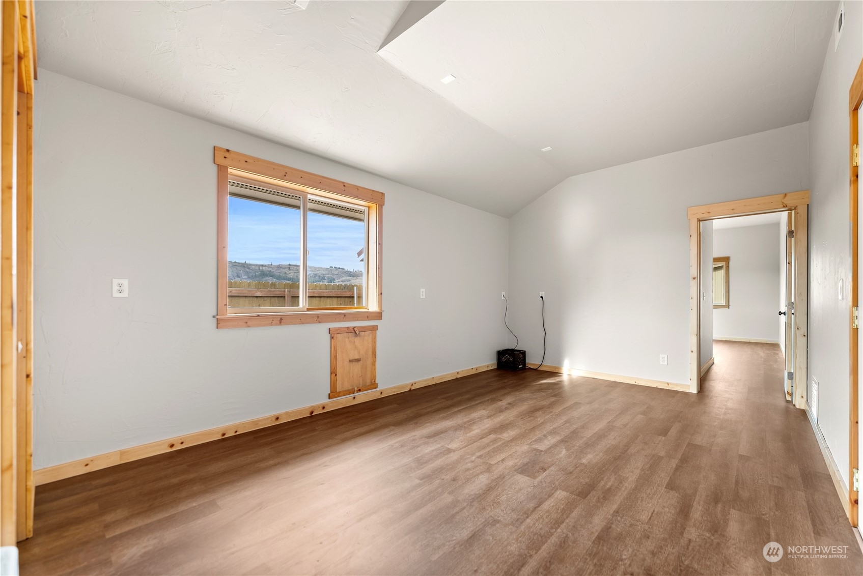 369 Tunk Creek Road Riverside, WA 98849 - Photo 37 of 40 a view of an empty room with wooden floor and a window
