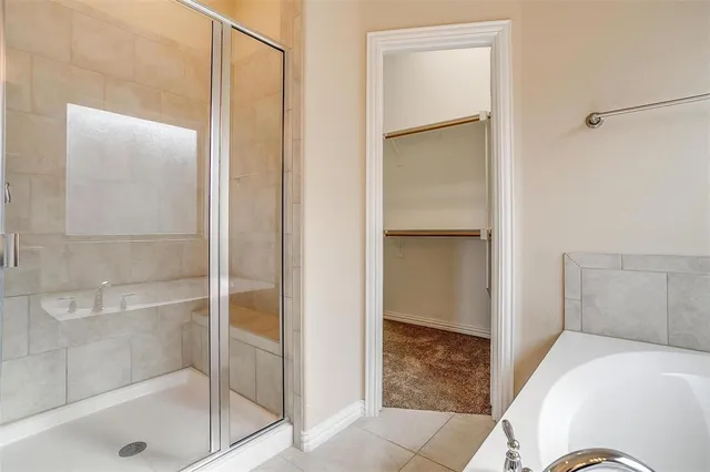 a bathroom with a tub and shower
