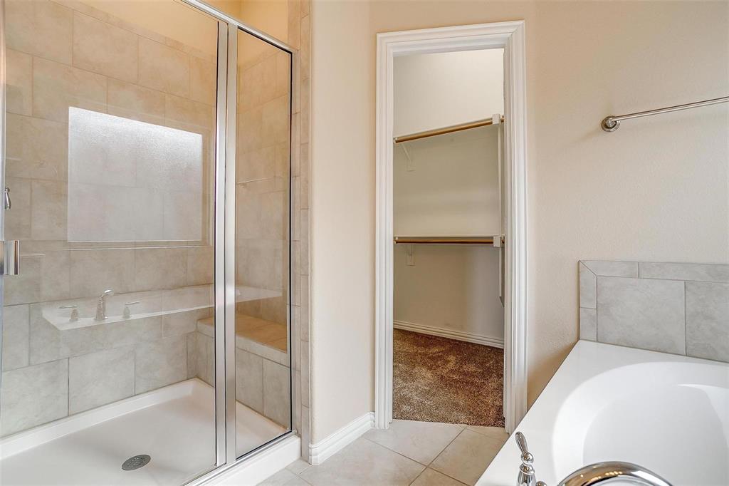 205 Mineral Point Drive Aledo, TX 76008 - Photo 17 of 38 a bathroom with a tub and shower