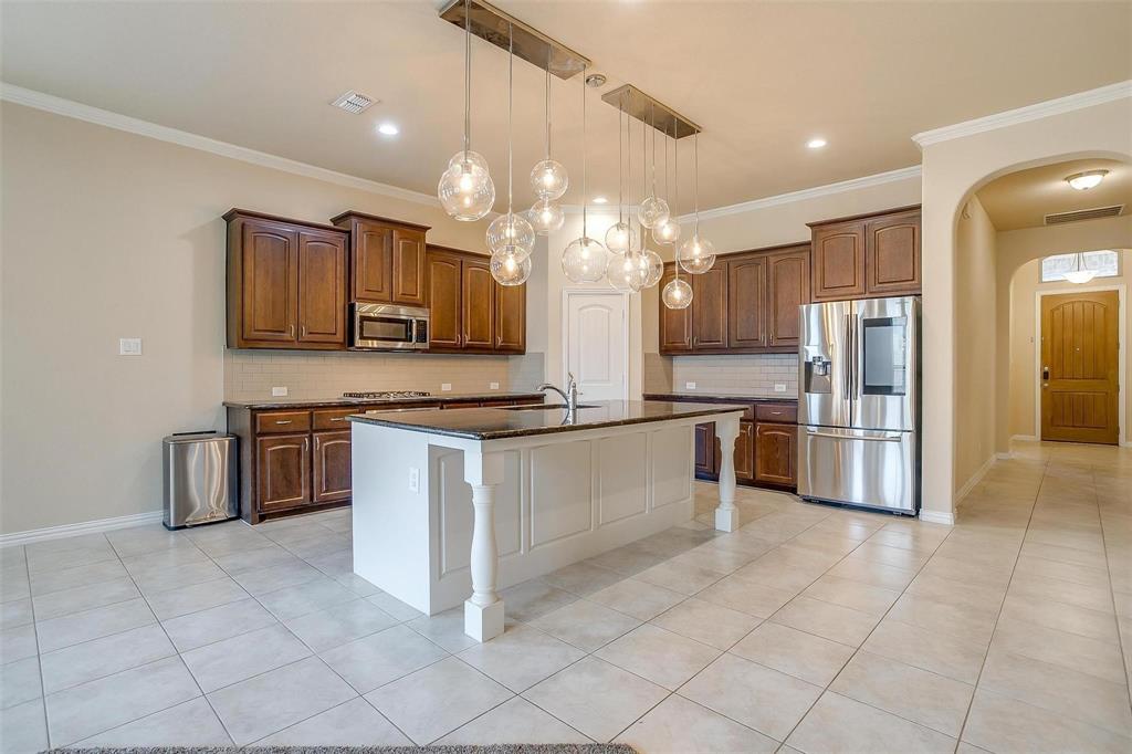 205 Mineral Point Drive Aledo, TX 76008 - Photo 8 of 38 a kitchen with stainless steel appliances a refrigerator sink and microwave
