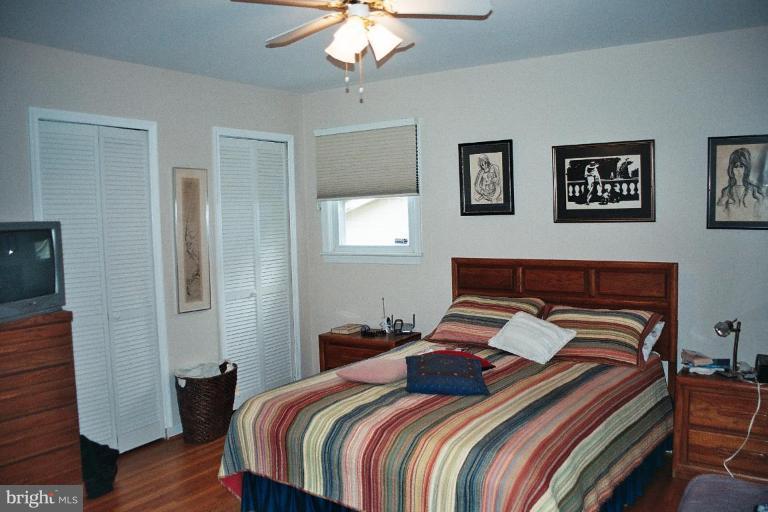 612 Kenbrook Drive Silver Spring, MD 20902 - Photo 8 of 11 a bedroom with bed and wooden floor