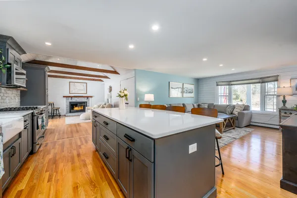 a kitchen with stainless steel appliances a stove microwave and sink