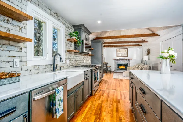 a dining area with stainless steel appliances kitchen island granite countertop wooden cabinets and chairs