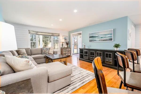a large kitchen with stainless steel appliances granite countertop a lot of counter space and wooden floors