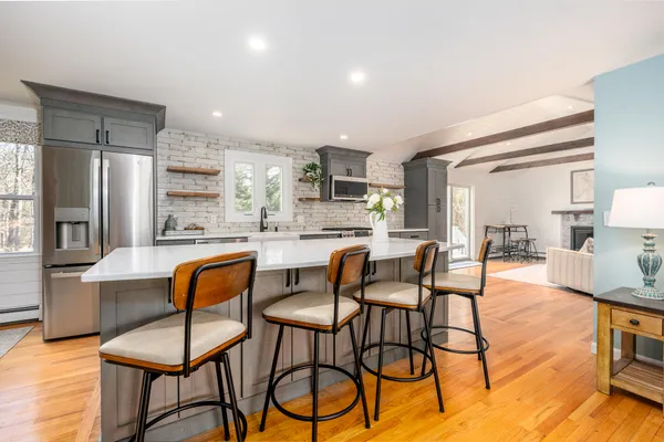 a kitchen with stainless steel appliances a stove a sink and a microwave