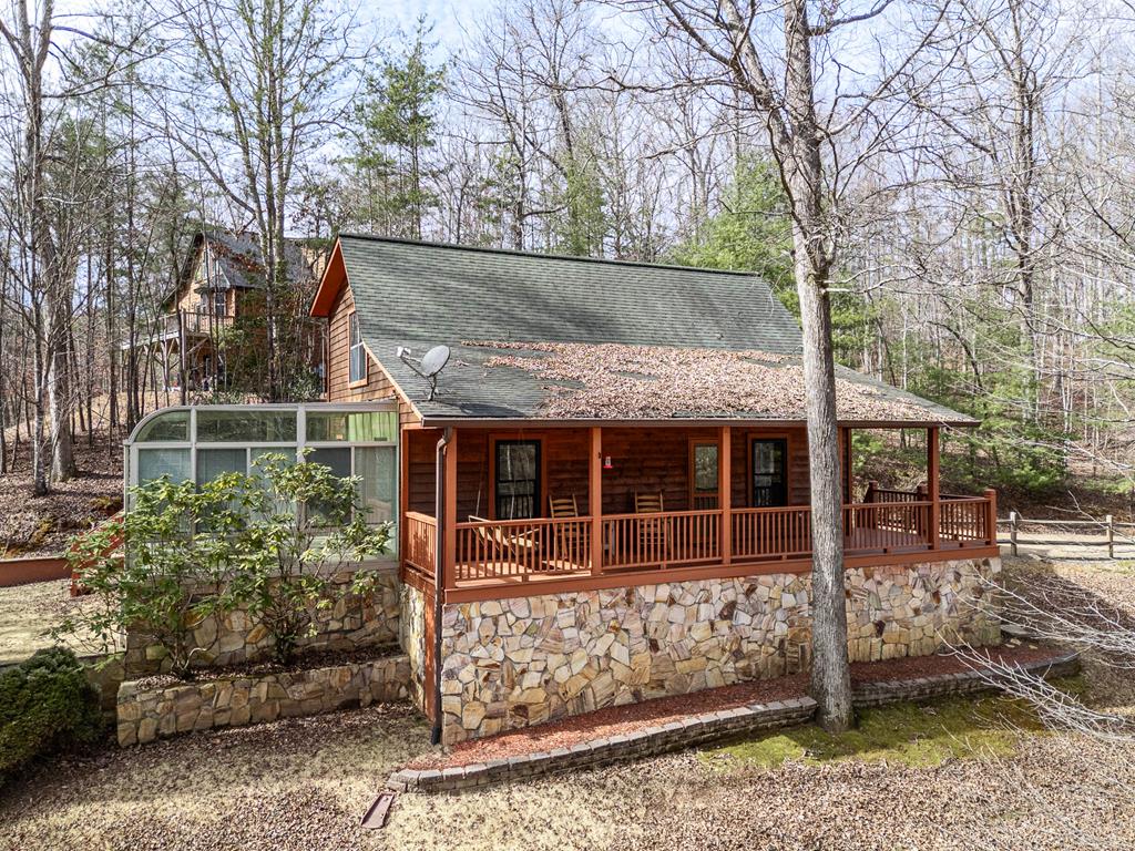 a view of house with a tree and wooden fence