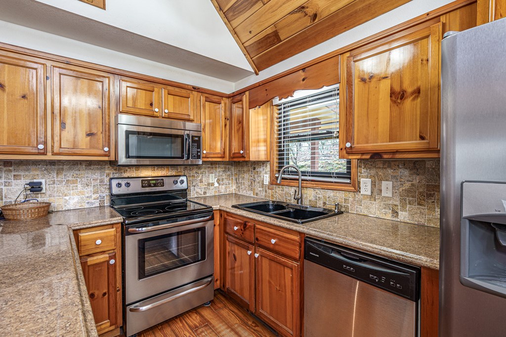 41 Carvers Vw Trail Murphy, NC 28906 - Photo 12 of 46 a kitchen with stainless steel appliances a stove sink microwave and cabinets