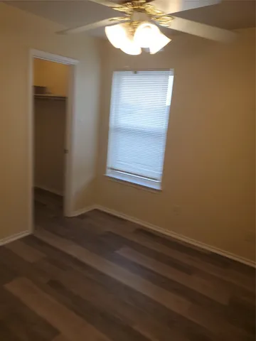 a view of a room with wooden floor