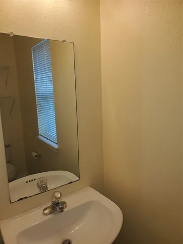 a bath room with a toilet a sink and a bath tub