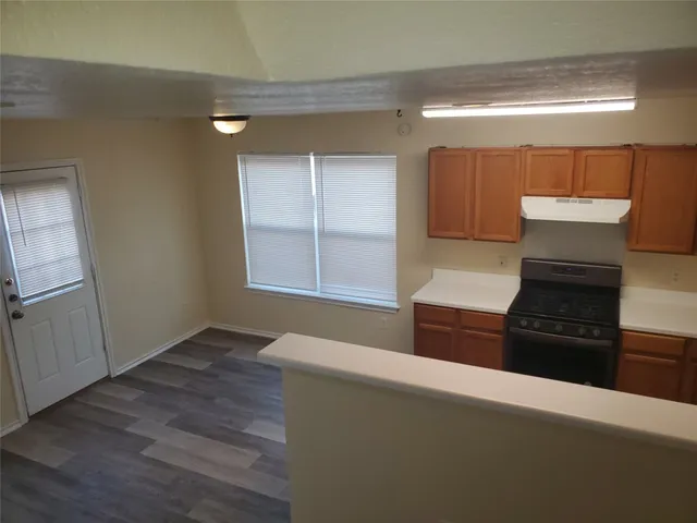 a view of a room with wooden floor