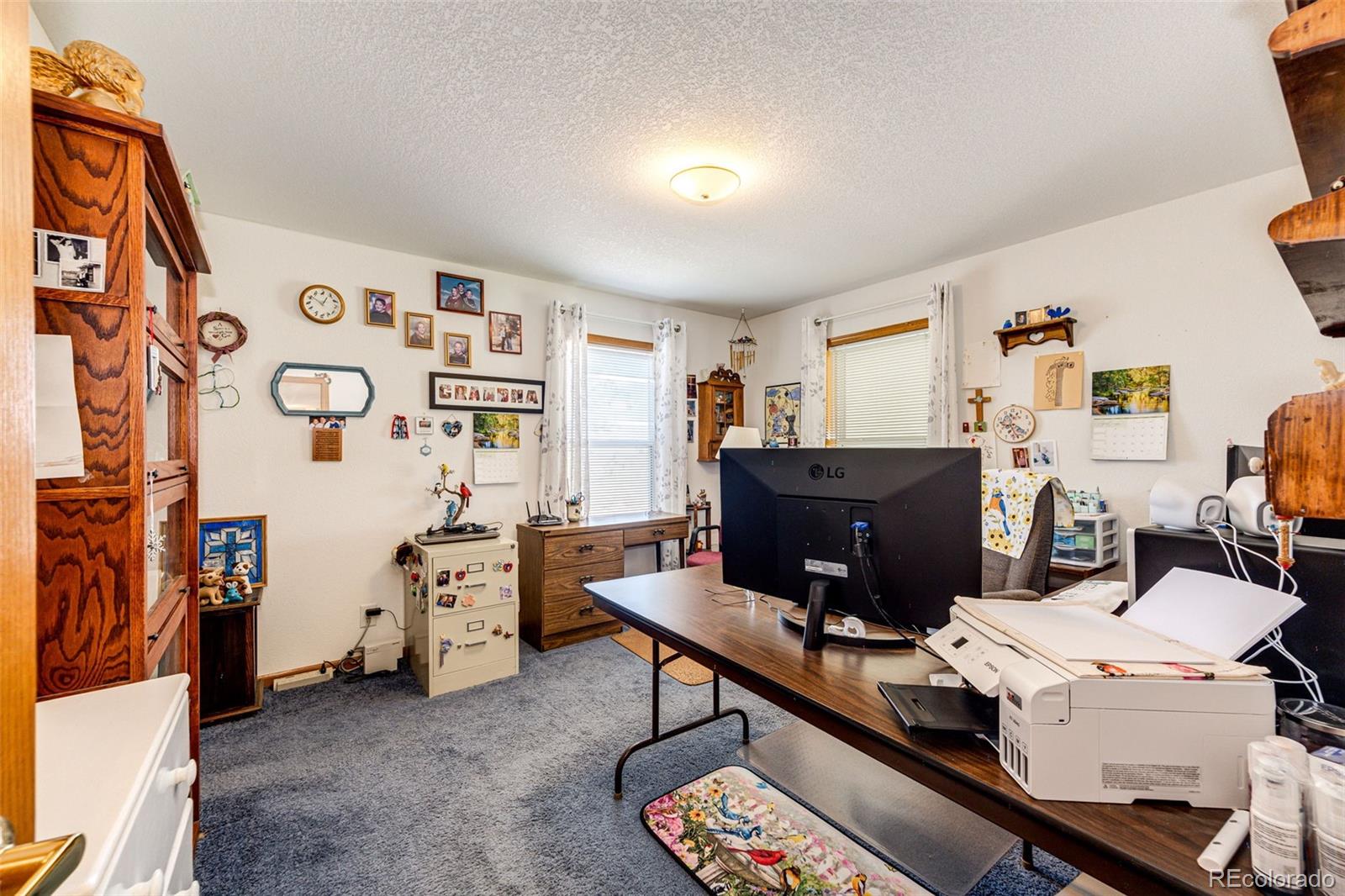 4420 Behrens Road Byers, CO 80103 - Photo 11 of 39 a room with furniture a rug and a wooden floor