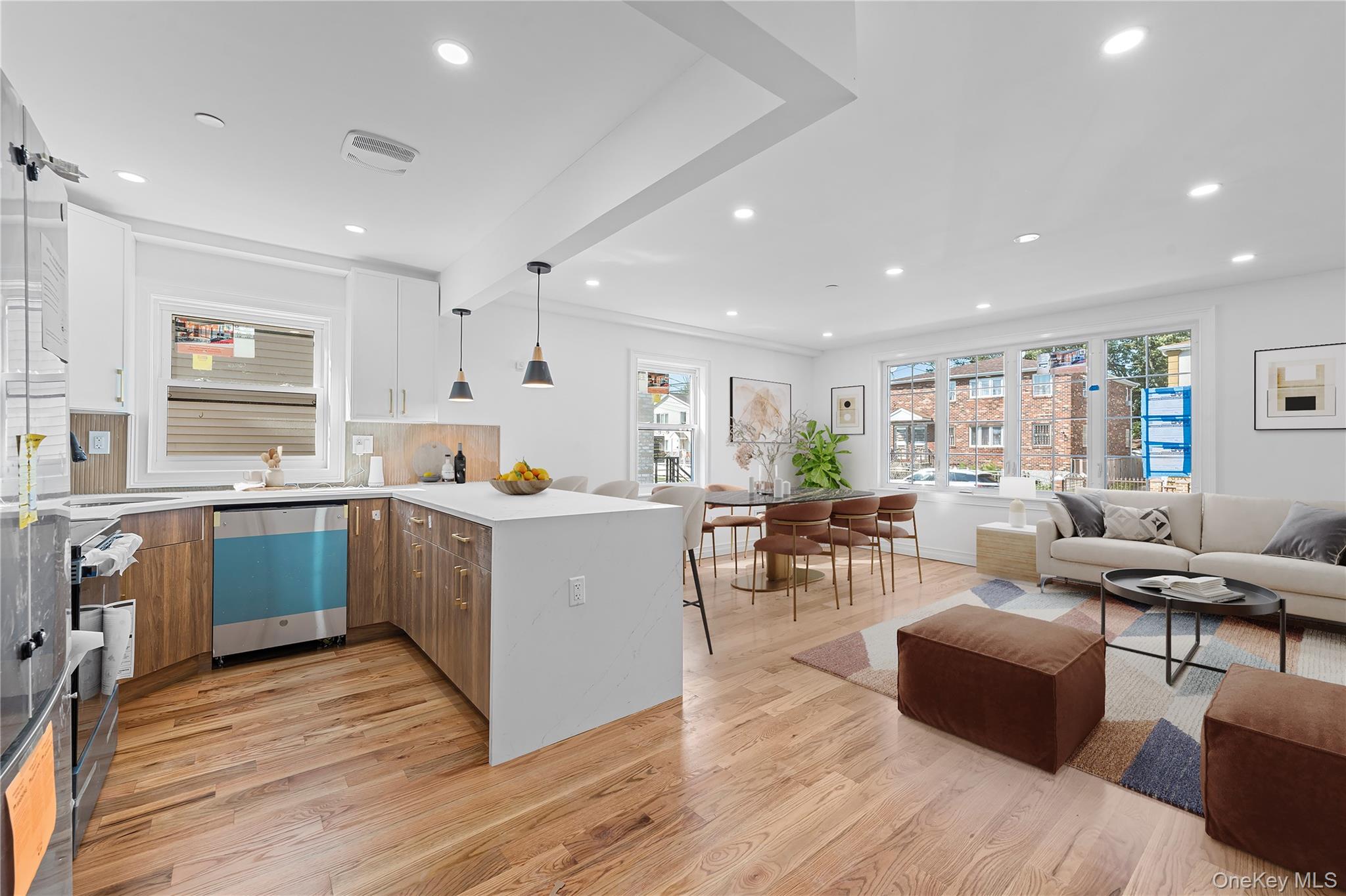 258-14 147th Road Queens, NY 11422 - Photo 22 of 22 Kitchen featuring light wood finished floors, beamed ceiling, open floor plan, stainless steel appliances, and light stone counters