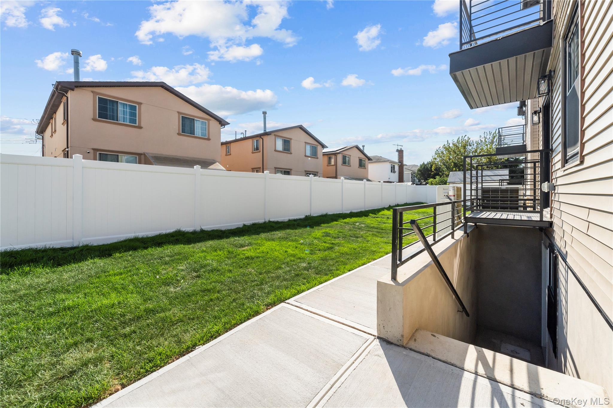 258-14 147th Road Queens, NY 11422 - Photo 19 of 22 View of yard featuring a residential view, a balcony, and a patio