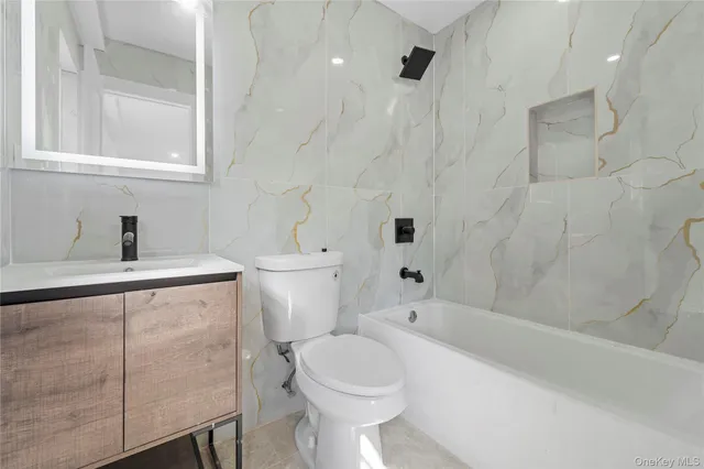 a bathroom with a toilet sink and bathtub